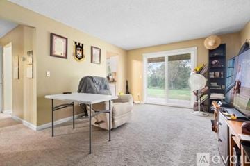 Rosemount apartment for rent - A living room with a grey sofa and a white table.