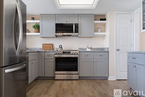 St. Pete Beach house for rent - A kitchen with a stainless steel refrigerator and wooden floors.