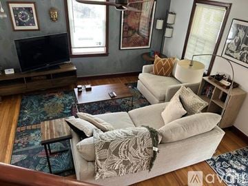 Washington house for rent - A living room with a grey couch and a wooden coffee table.