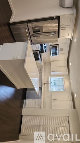 Tacoma townhouse for rent - A kitchen with a stainless steel refrigerator, oven, and cabinets.