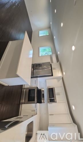 Tacoma townhouse for rent - A modern kitchen with a stove, oven, microwave, and sink.
