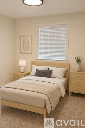 Tacoma townhouse for rent - A bedroom with a bed, nightstand, and window.