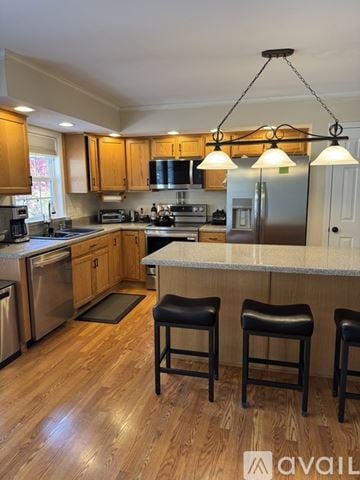 Asheville house for rent - A kitchen with wooden cabinets and a stainless steel refrigerator.