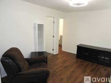 San Diego apartment for rent - A living room with a brown leather chair and a black coffee table.