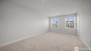 Miami condo for rent - A room with beige carpet and two windows showing a view of buildings outside.