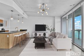 Miami condo for rent - A modern living room with a bar area and a flat screen TV.