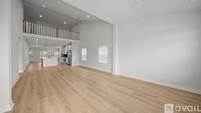 Miami condo for rent - A spacious room with wooden flooring and white walls.