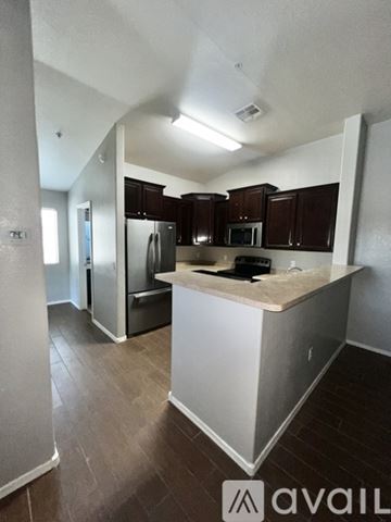 Goodyear townhouse for rent - A living room with a grey couch and a glass table.