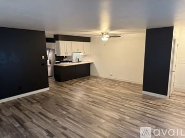 Slinger apartment for rent - A spacious room with a kitchen area in the background.