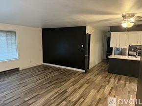 Slinger apartment for rent - A room with wooden flooring and a black wall.
