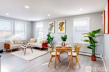 Providence apartment for rent - A living room with a dining table set for two and a couch.