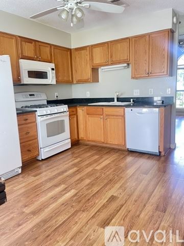Oxford house for rent - A kitchen with wooden cabinets and a white fridge.