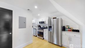 Waltham apartment for rent - A kitchen with a refrigerator, oven, and microwave.