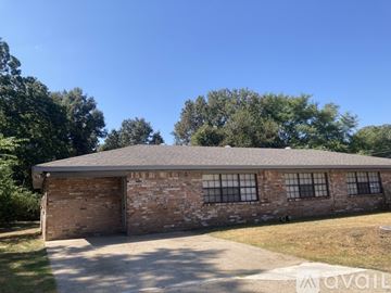 Tyler house for rent - A kitchen with wooden cabinets and a microwave on the counter.