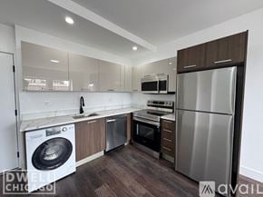 Chicago apartment for rent - A modern kitchen with a refrigerator, oven, and washing machine.