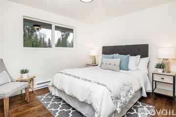 Chicago apartment for rent - A bedroom with a large bed and a chair.