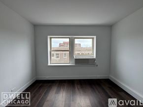 Chicago apartment for rent - A room with a window showing a view of a building outside.