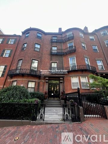 Boston apartment for rent - A brick building with a black fence in front.