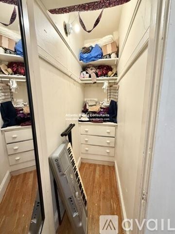 Boston apartment for rent - A kitchen with white cabinets and a window.
