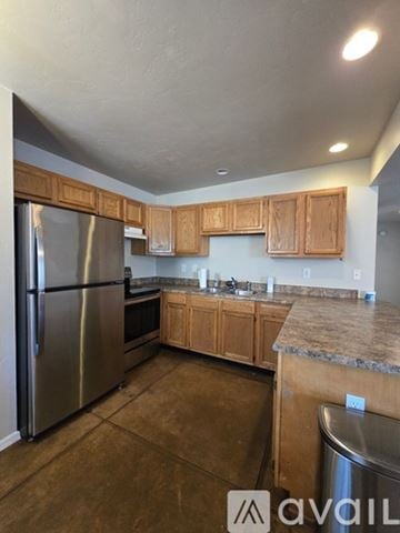 San Diego house for rent - A kitchen with wooden cabinets and a granite countertop.