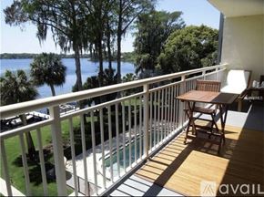 Winter Park apartment for rent - A balcony with a table and chairs overlooking a body of water.