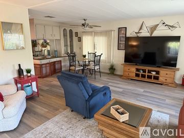Cathedral City apartment for rent - A living room with a blue chair and a wooden coffee table.
