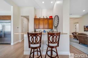 La Quinta house for rent - A kitchen with two chairs and a bar area.