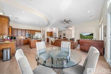 La Quinta house for rent - A modern living room with a glass table and grey chairs.