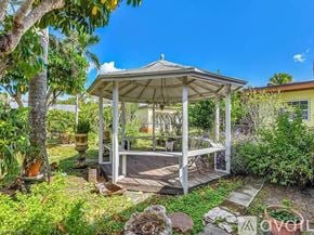Davidson apartment for rent - A gazebo is surrounded by green plants and trees.