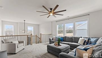Davidson apartment for rent - A living room with a grey sofa and a ceiling fan.