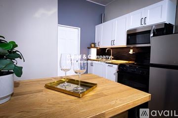 Davenport house for rent - A kitchen with a wooden table and a tray with two glasses on it.