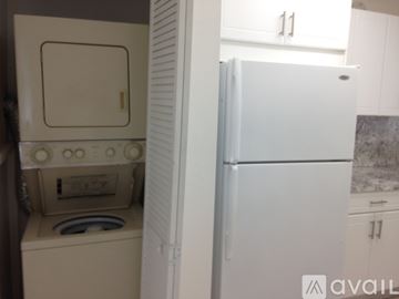 Hialeah apartment for rent - A kitchen with white cabinets and a marble backsplash.