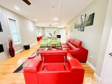Cedar Rapids house for rent - A living room with red couches and a green couch in the background.