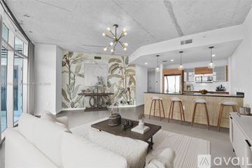 Ocala house for rent - A modern living room with a large painting on the wall and a bar area in the background.