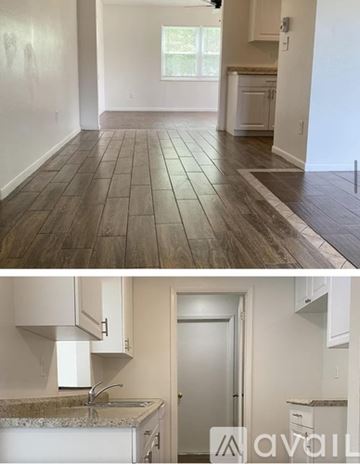 Spring Hill house for rent - A kitchen with white cabinets and a marble countertop.