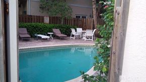 Fort Lauderdale townhouse for rent - A pool surrounded by chairs and plants.