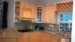 Fort Lauderdale townhouse for rent - A bedroom with a large bed and a window with curtains.