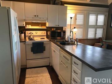 St. Simons Island house for rent - A living room with a fireplace and a television on the wall.