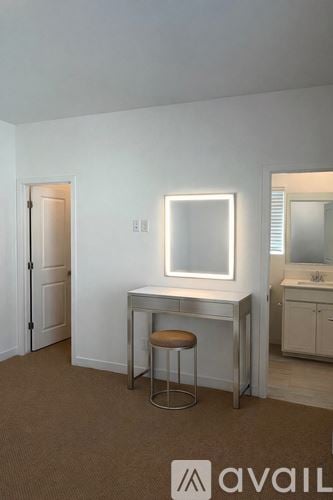 Phoenix house for rent - A bedroom with a large bed and a chair.
