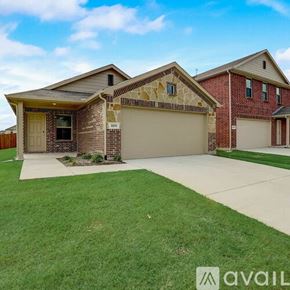 Mckinney house for rent - A house with a brown brick facade and a beige garage door is for sale.