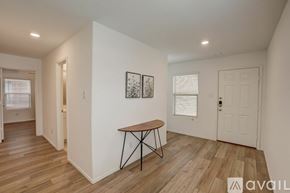 Mckinney house for rent - A room with a wooden floor and a table with a metal base.