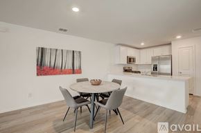 Mckinney house for rent - A dining room with a white table and chairs and a painting on the wall.