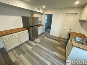 Pittsburgh apartment for rent - A kitchen with a refrigerator, cabinets, and a sink.