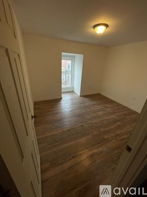 Pittsburgh apartment for rent - A room with wooden floors and a door on the left.
