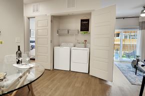 Austin apartment for rent - A modern kitchen with a glass table and a wine bottle on it.