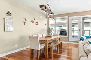 Calgary apartment for rent - A dining room with a wooden table and chairs.