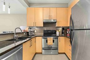 Calgary apartment for rent - A kitchen with wooden cabinets and a black refrigerator.
