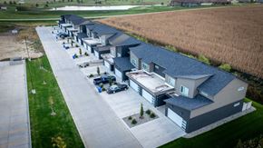 Sioux Center apartment for rent - A row of houses with a parking lot in front.