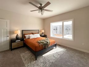 Sioux Center apartment for rent - A bedroom with a bed, nightstands, and a ceiling fan.