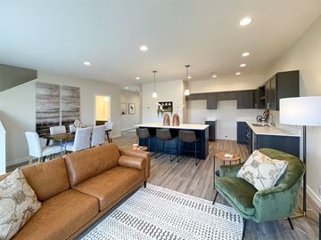 Sioux Center apartment for rent - A living room with a brown couch and a green armchair.